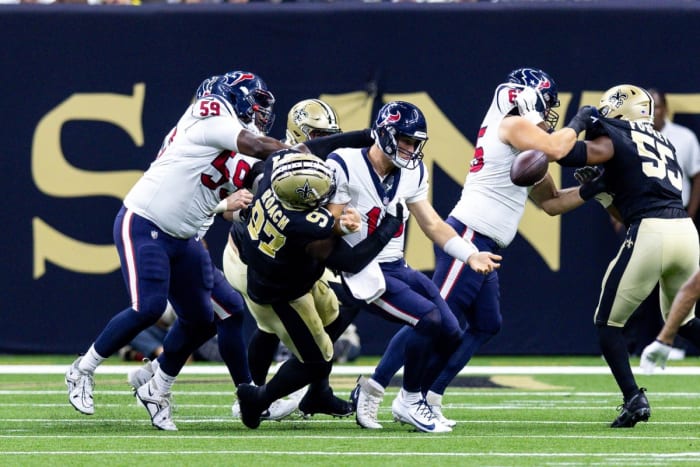 Aug 27, 2023; Houston Texans quarterback Davis Mills (10) is sacked by New Orleans Saints defensive end Malcolm Roach (97), who forces a fumble on the play. Mandatory Credit: Stephen Lew-USA TODAY Sports